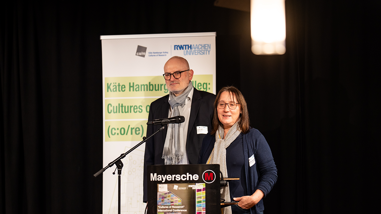 Two people together at a podium.